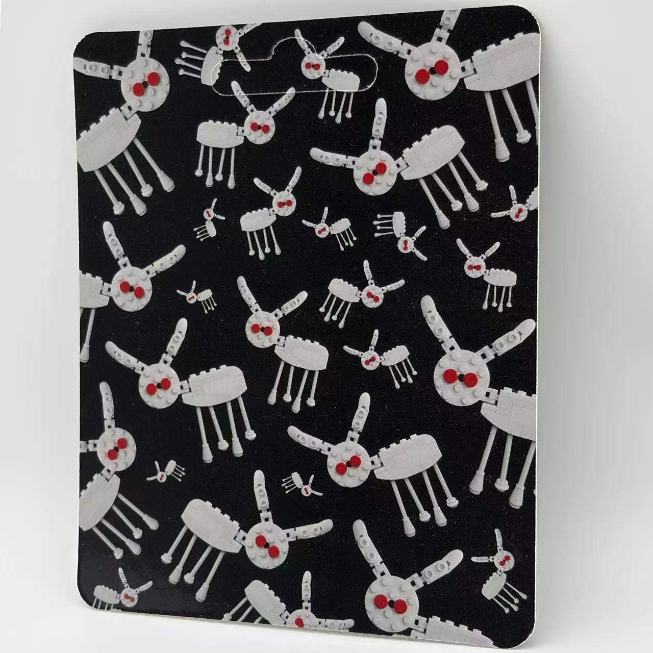 Drake "For All The Dogs" minifigure packaging with artistic dog pattern, black background, vibrant red accents.