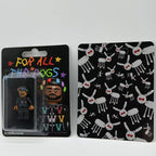 Drake "For All The Dogs" custom minifigure with black hoodie, colorful hair clips; includes artistic card.