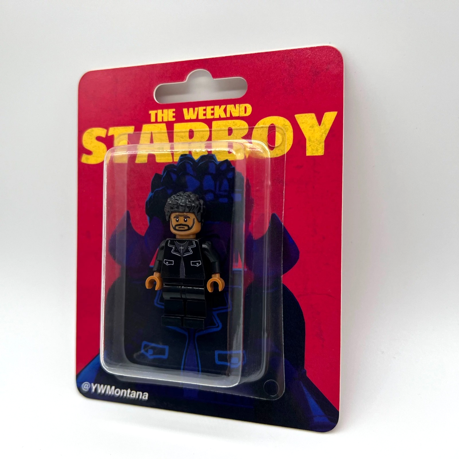 The Weeknd "Starboy" custom minifigure in black jacket, packaged with red "STARBOY" album art backing.