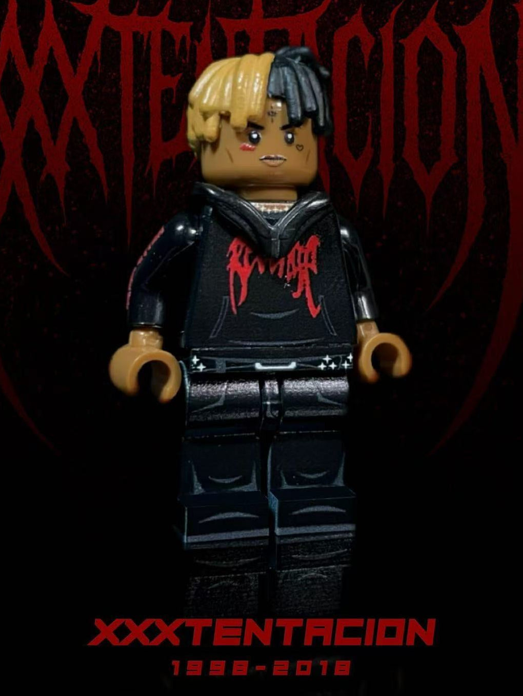 XXXTENTACION custom minifigure with half-black half-yellow braids, red "BAD" hoodie, black jeans.