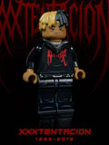 XXXTENTACION custom minifigure with half-black half-yellow braids, red "BAD" hoodie, black jeans.